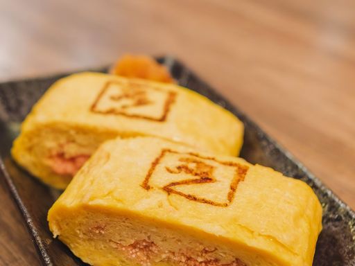 Japanese tamagoyaki omelette served on a plate.
