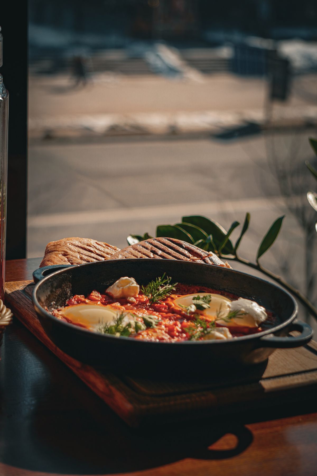 Shakshuka served in a skillet with crusty bread.