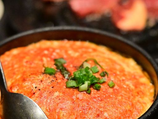 Korean steamed egg garnished with sliced green onions.