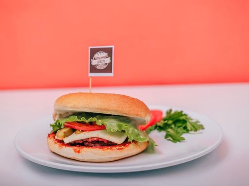 Vegetarian burger with lettuce, cheese and tomato on a plate