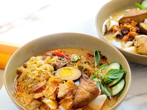 A bowl of sayur lodeh with tofu and boiled egg.
