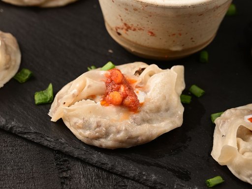 Mantu steamed dumplings with tomato sauce