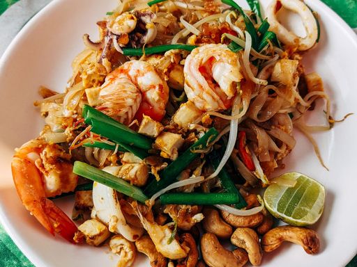 Thai seafood Pad Thai with shrimp, sprouts, lime, and cashews.
