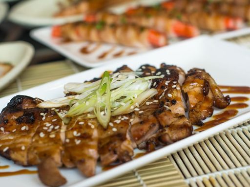 Grilled chicken teriyaki topped with leeks and sesame seeds.