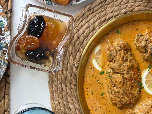 Moroccan chicken tagine served with rolls and preserved fruit.