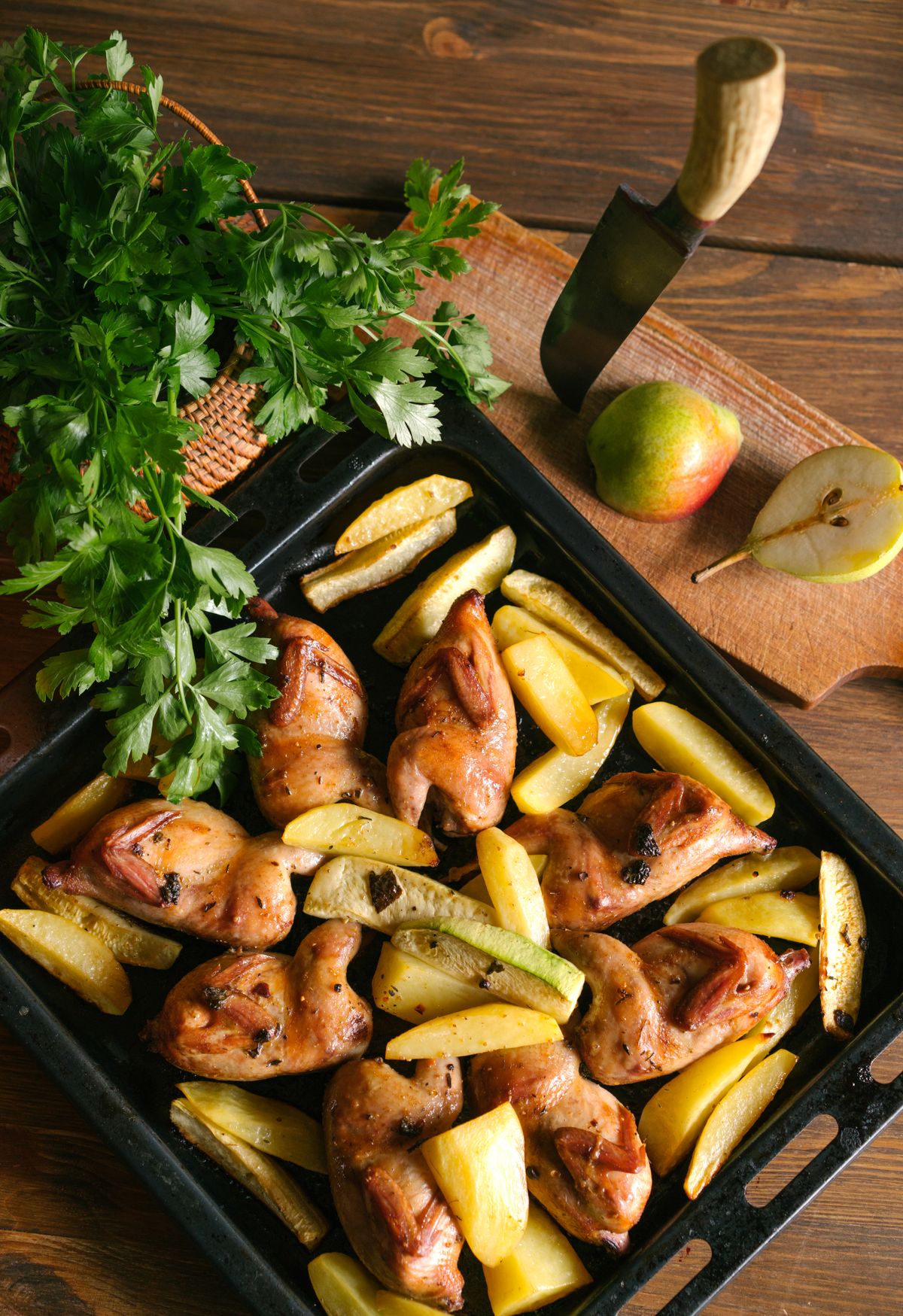 Roasted chicken legs served with golden potatoes.