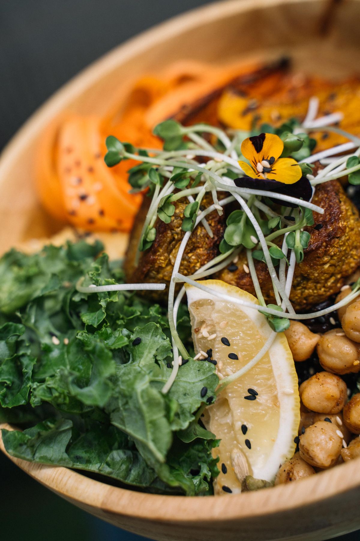 Vegan Buddha bowl with vegetables, chickpeas, and lemon.