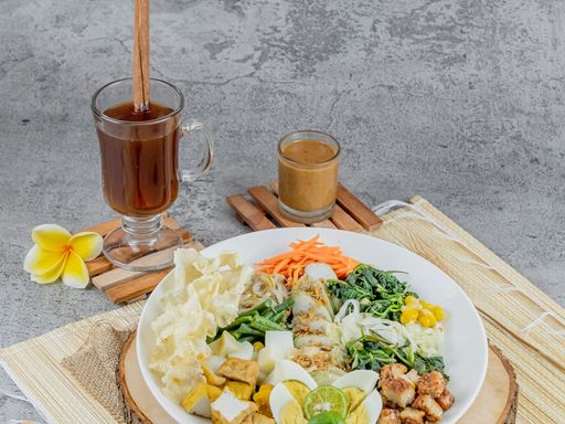 Gado-gado salad with fresh vegetables, eggs, and peanut sauce.