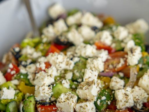 Greek salad with fresh vegetables, olives, and feta cheese.