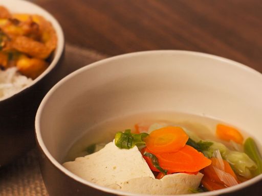 Homemade vegetable soup with soft tofu in a ceramic bowl