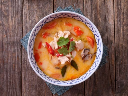 Thai Tom Kha Gai soup with chicken, coconut milk, and vegetables.