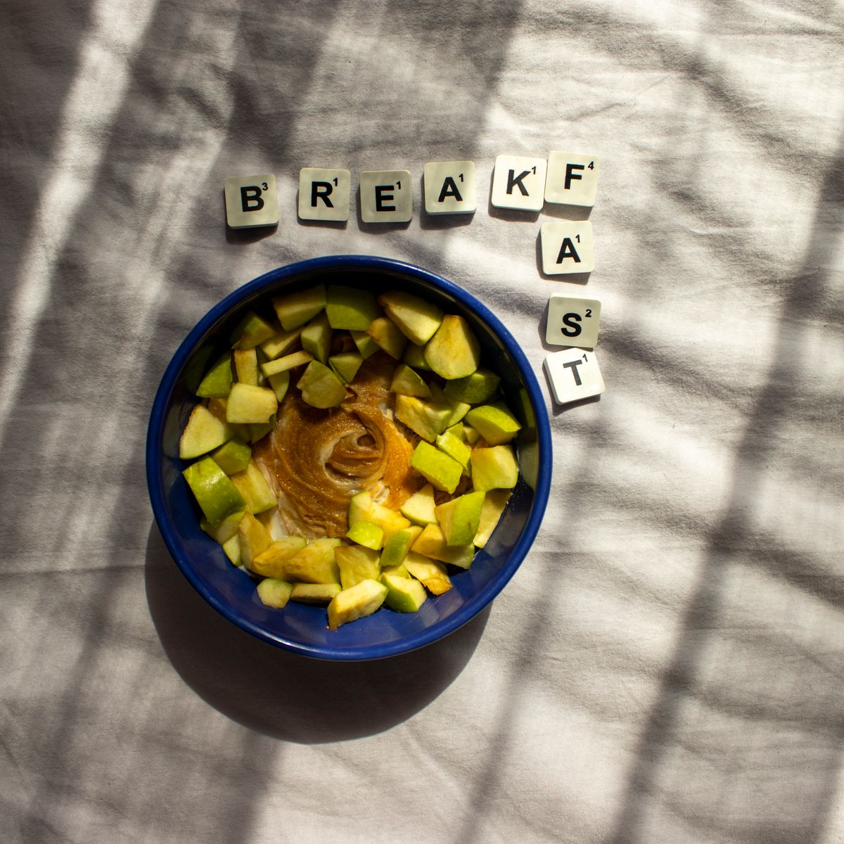 Breakfast bowl with apple slices and peanut butter.