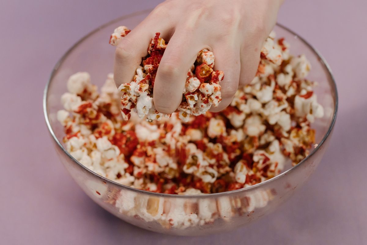 Spicy popcorn served in a glass bowl.